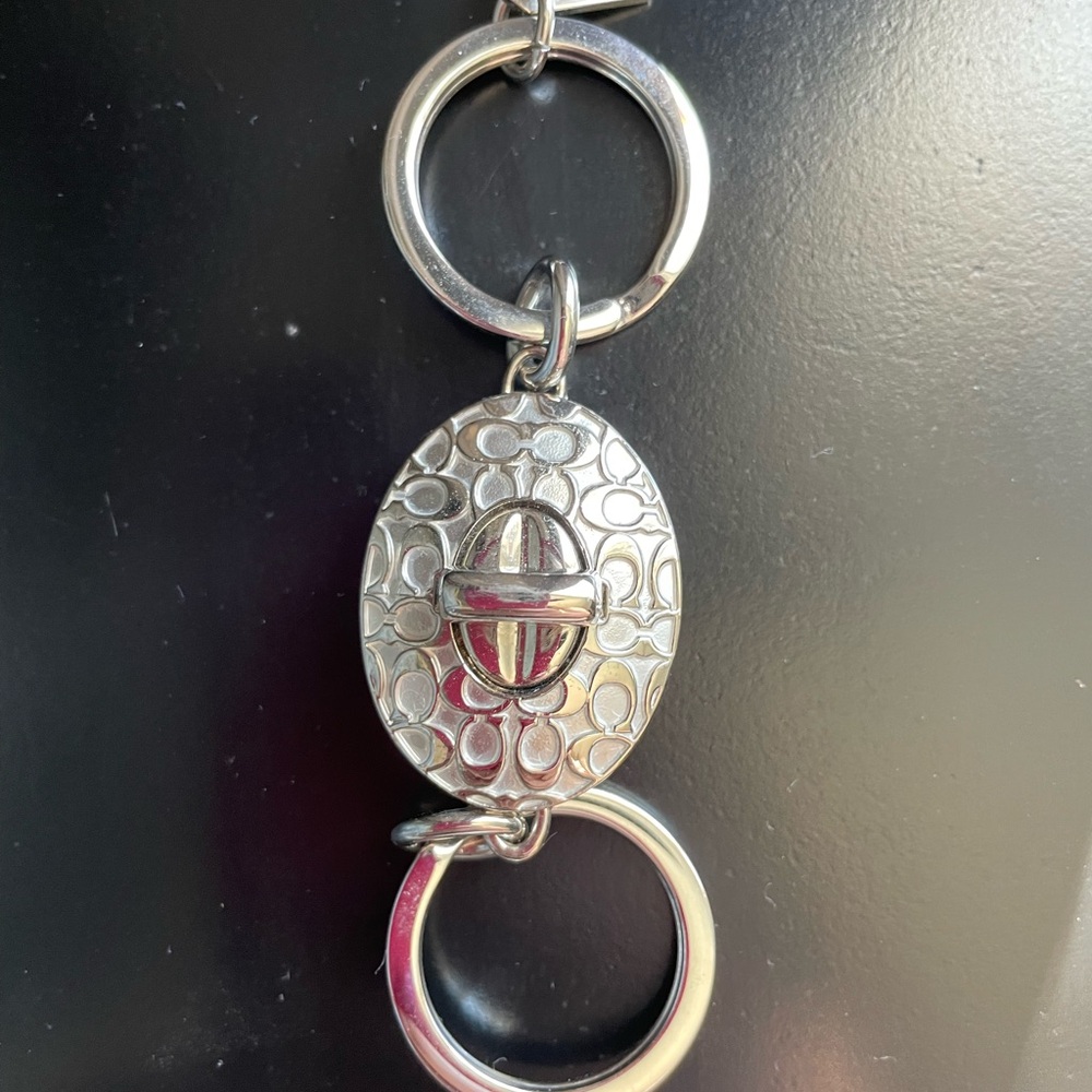 Coach Elegant Silver Keychain with Textured Oval Design